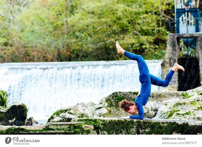 Woman balancing in Supported Headstand pose headstand yoga balance woman supported headstand pose salamba sirsasana mindfulness flexible nature female practice