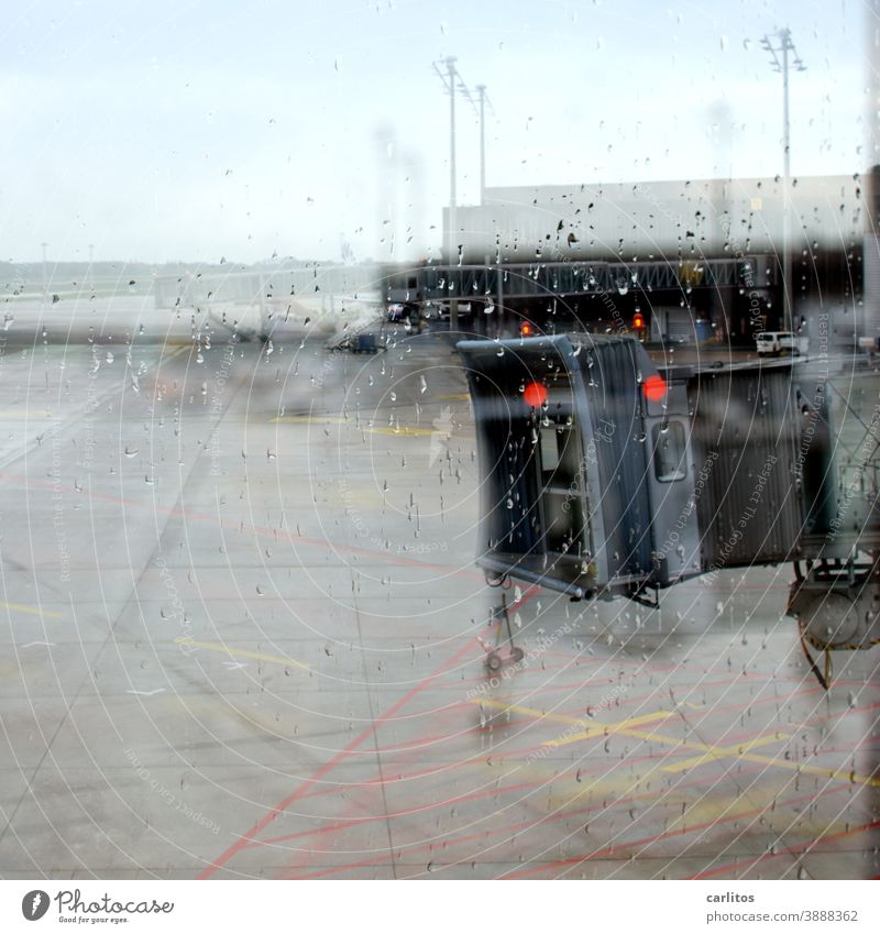 Off to the south| raindrops on the windscreen - passenger bridge in sight, but no aircraft Airport departure Arrival waiting zone waiting area Window Slice