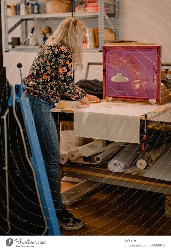 Young woman works in the screen printing workshop Pressure illustration Production Screen printing Workshop creative creation Handcrafts handcraft Eyeglasses