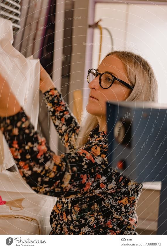 Young woman works in the screen printing workshop Pressure illustration Production Screen printing Workshop creative creation Handcrafts handcraft Eyeglasses