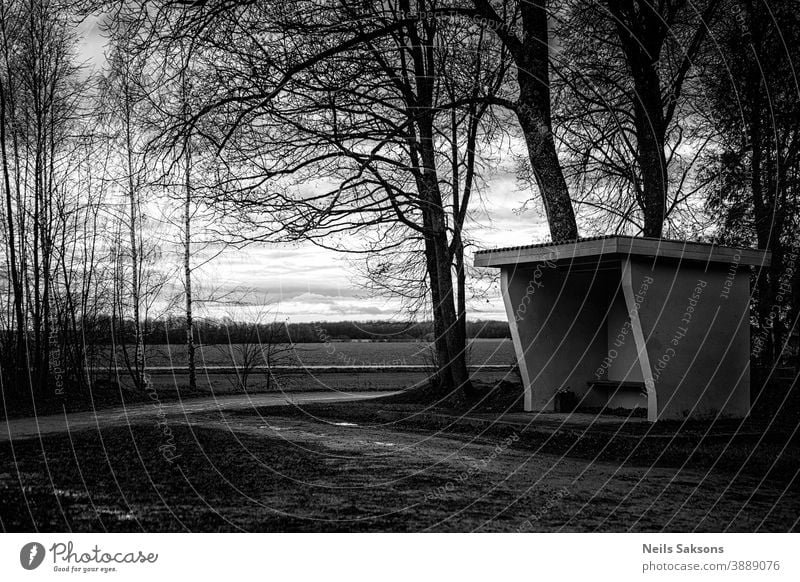 empty old bus stop by the road, waiting place for the bus in Latvian countryside Asphalt autumn city communication construction forest freeway highway