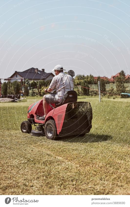 Man mowing his lawn using riding lawnmower occupation seasonal cut trimming man job person field professional ride gardener drive equipment worker male