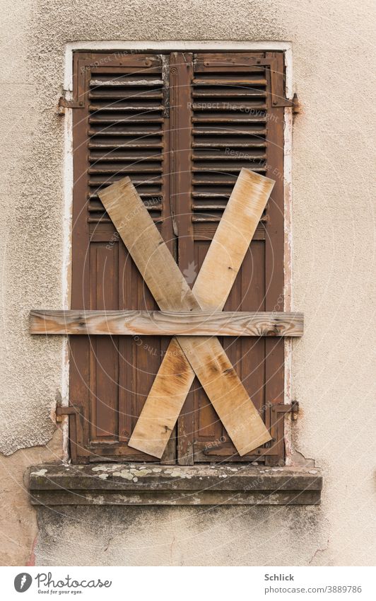 Totally too closed old wooden shutters with boards nailed crosswise Wooden folding shutter Old Closed criss-cross X dilapidated forsake sb./sth. Uninhabited