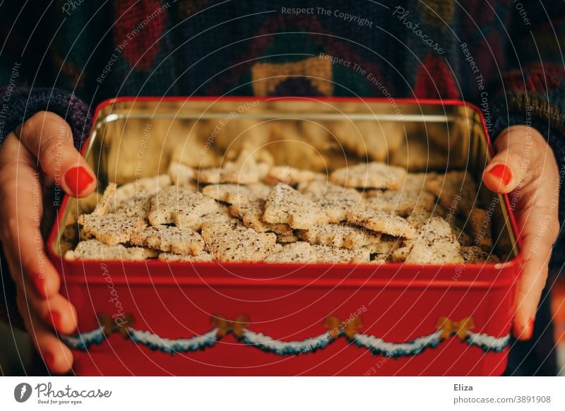 A woman holds a tin of homemade Christmas cookies in her hands Cookie Cookie jar Cookie tin fir trees biscuits Delicious Christmas & Advent Baked goods