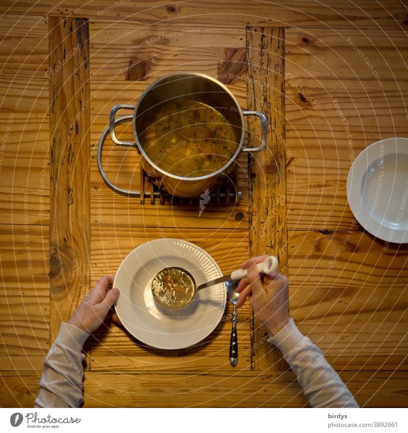 Pass out the soup, serve. Covered wooden table with soup pot, soup ladle, plate and spoons. Bird's eye view Soup Stew Plate Spoon Eating hands Arm Lunch