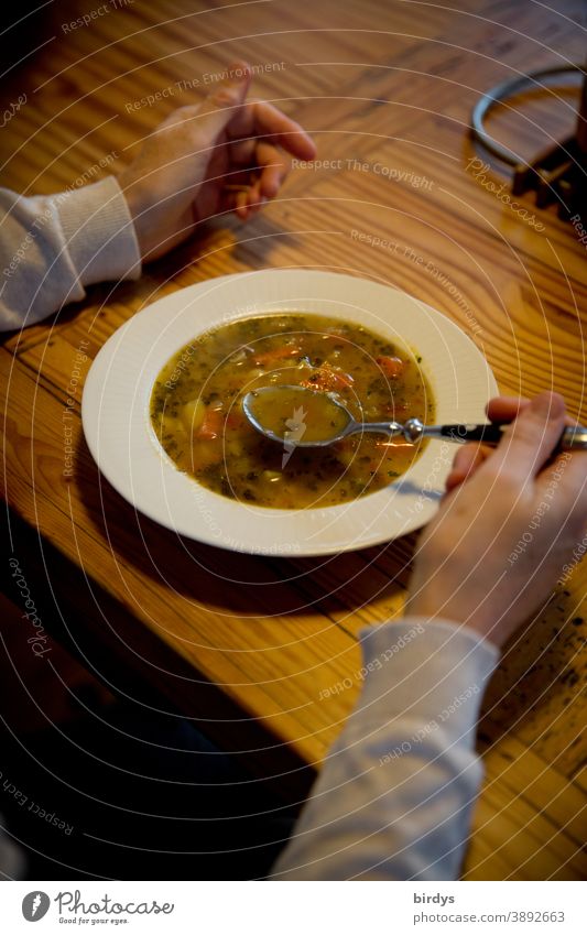 For lunch we have stew. Spoon a plate of soup. Soup Stew Plate Eating hands Lunch Spoon up Wooden table Nutrition at home Bowl Healthy Eating hunger