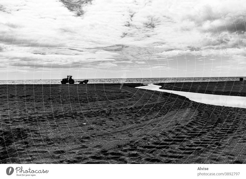 winter beach with tractor, sand and stream spain sea travel coast mediterranean estepona water vacation tourism sun andalusia nature landscape coastline europe