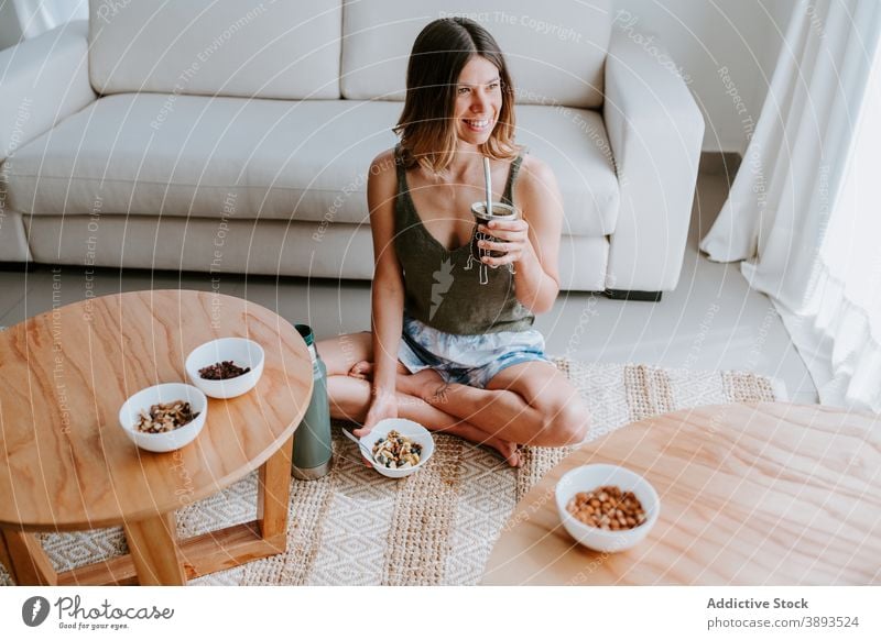 Cheerful woman having healthy breakfast at home healthy food granola eat detox muesli diet bowl female drink vitamin tasty sit morning meal cheerful fresh