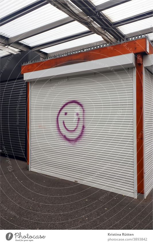 smiley on closed roller shutter of a market stall Market stall sales booth Load Closed Markets Smiley Face Smiling Positive cheerful joyfully street art