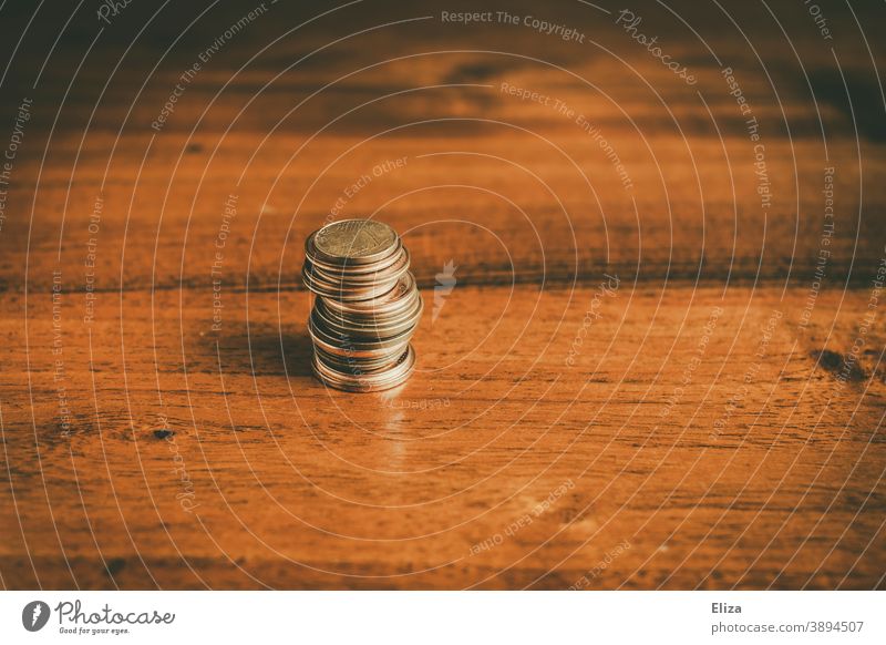 Stacked cent coins on a wooden table Coins Money stacked small change Little Charity Cent Poverty copper coins