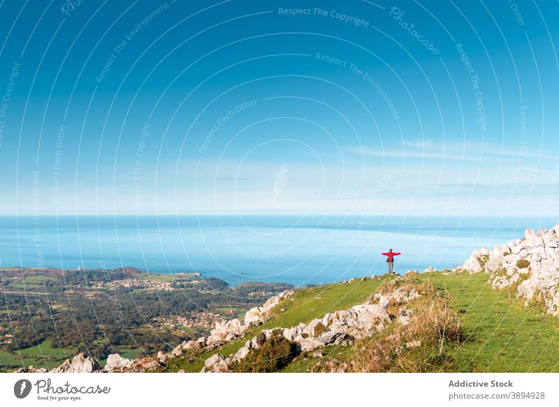 Anonymous traveler enjoying freedom in mountains outstretch arm hiker sea seascape highland el mazuco asturias spain cliff edge journey adventure wanderlust