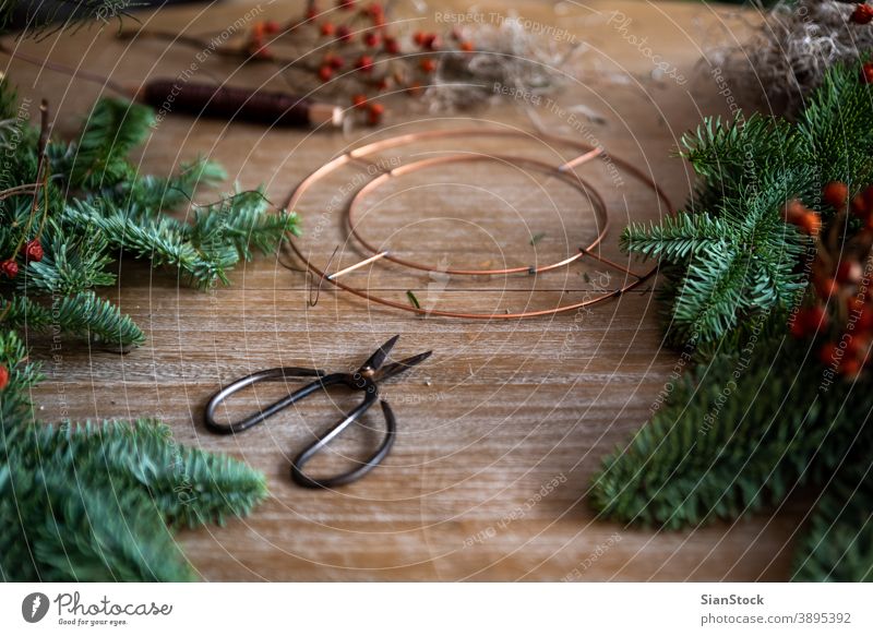 Woman making a Christmas crown from winters leaves outdoor leaf nature hand cristmas woman flower cornet fresh midsummer festival garden june religion wreath