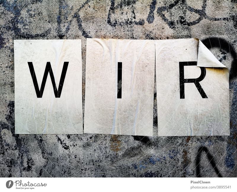 What we need is cohesion Characters Letters (alphabet) Word Typography Wall (building) Signs and labeling Facade Exterior shot We, together