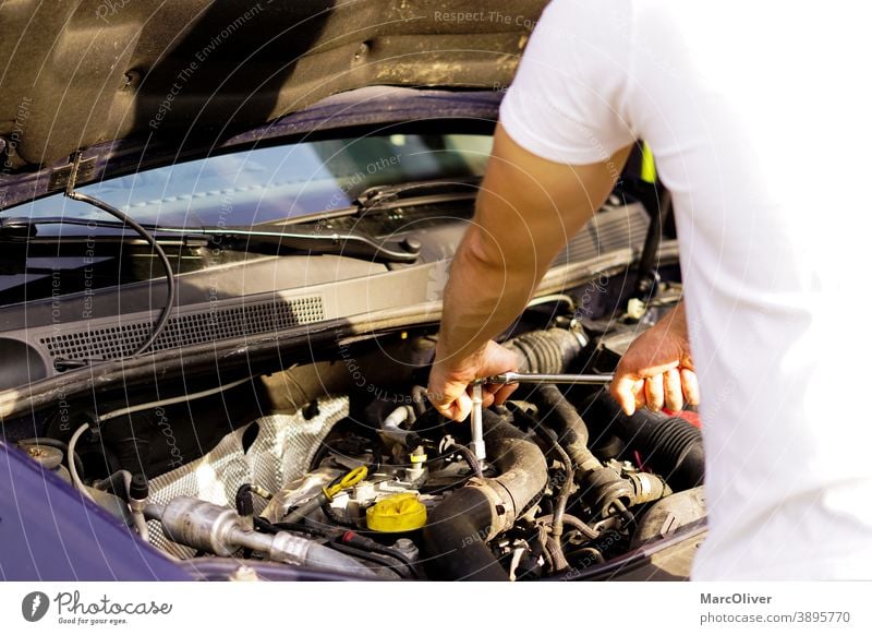 repairman is fixing the car engine checking a car engine eninge repair engine damage car maintenance car mechanic motorcar mechanic fixing an engine car repair