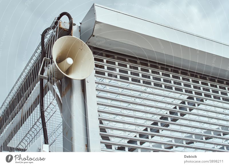 Speaker for announcing outdoor. Public megaphone on building construction public attention siren speaker concept announcement horn voice bullhorn loudspeaker