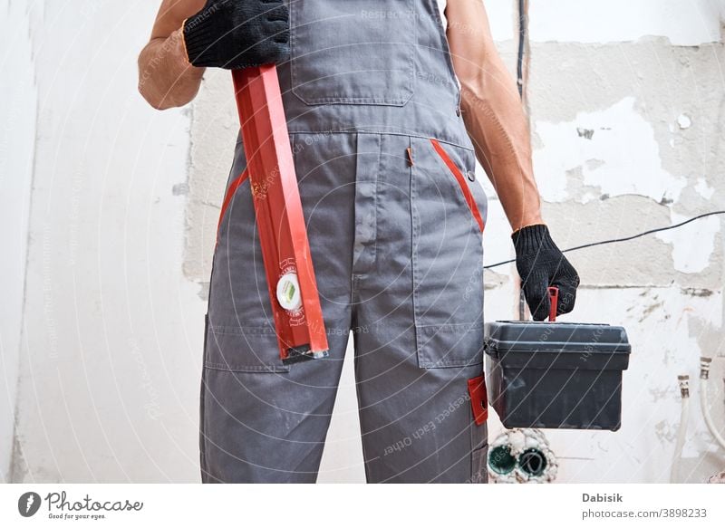 Builder man in uniform with construction tools. Repair concept renovation repair instrument equipment handyman protection builder male worker protective people