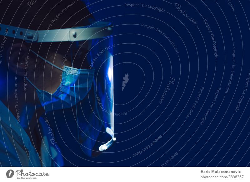 woman doctor with face shield and mask side view on dark blue background black background brazil corona epidemic corona virus covid-19 covid-19 test doctors