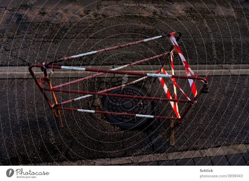 Blocking off a small construction site Danger zone illuminated by car headlights at night cordon Construction site danger spot Red White Headlamp Car headlights