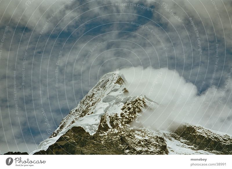 Peru, Santa Cruz Trek Glacier Mountain Snowcapped peak Clouds in the sky Landscape Fog Haze Copy Space top Bright background Snowscape