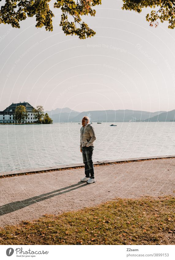 Sporty pensioner in the evening sun at lake Attersee Lake Attersee sunset Evening Sunset Nature Dusk Landscape Idyll Austria Lakeside Exterior shot Smiling