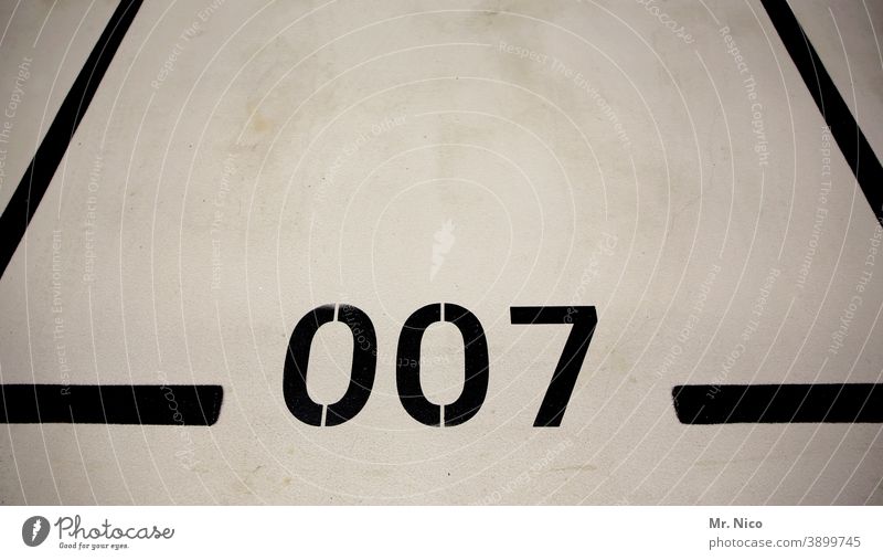 Agent parking lot Digits and numbers Line Black Parking lot Parking garage Signs and labeling Parking level 007 James Bond Boundary Empty Garage