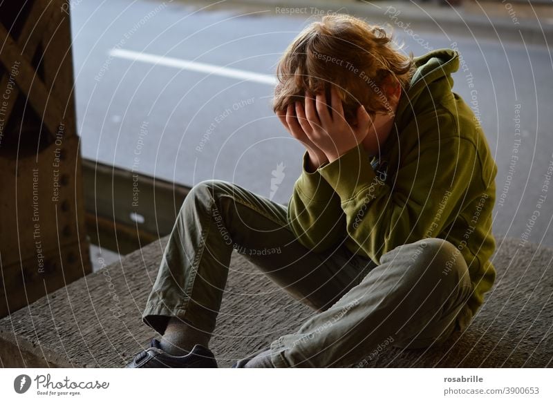 Life breaks | little boy sits desperately crying with his hands in front of his face in an underpass sad Child Boy (child) Cry by oneself Grief Concern Fear