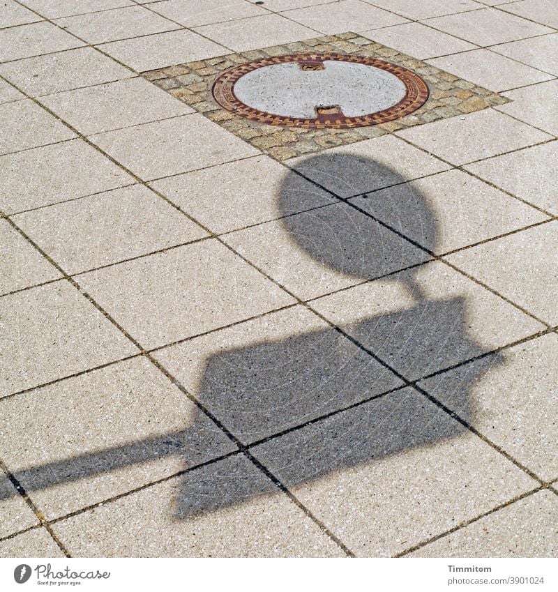 Hello there!? manhole cover Shadow Road sign slabs Places Lines and shapes Approach proximity Structures and shapes Deserted