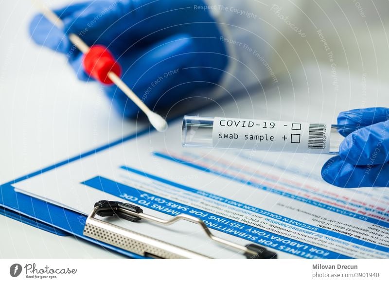 Medical worker holding Coronavirus COVID-19 NP OP swab sample test kit, nasal collection equipment, CDC submitting form, reverse transcription RT-PCR DNA molecular nucleic acid diagnostic procedure