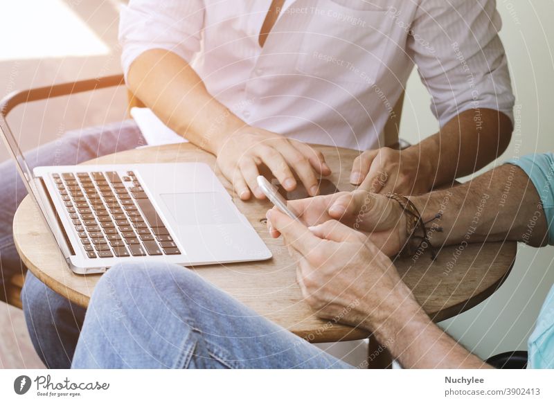 Two businessman meeting and using smartphone with laptop at outdoor cafe gadget wifi hipster young internet social web connection network hand media concept