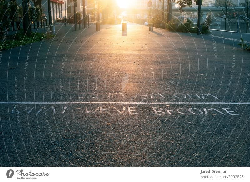 Who we were, What we've become - Inspirational message on the streets of Lyon Quote Street inspirational street sign Meaningful black asphalt Road marking Sign