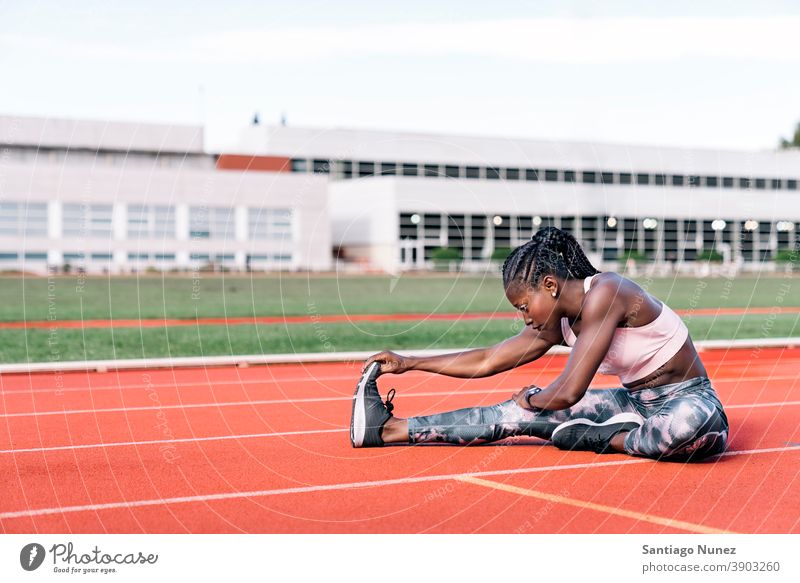 Athlete sprinter stretching her legs control race run competition athlete athletics competitive ready line beginnings compete competitor olympic olympics sports