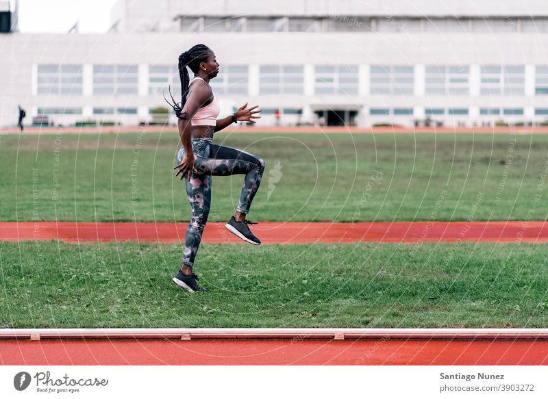 African-American athlete warming up determined muscular jump afro american sprinter beginning african ambition motivation movement dynamic workout training