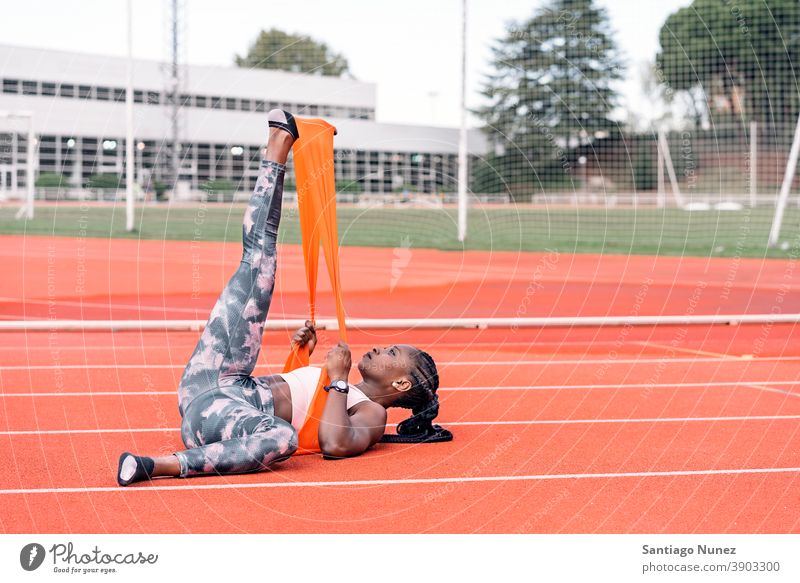 Athlete sprinter stretching her legs control race run competition athlete athletics competitive ready line beginnings compete competitor olympic olympics sports