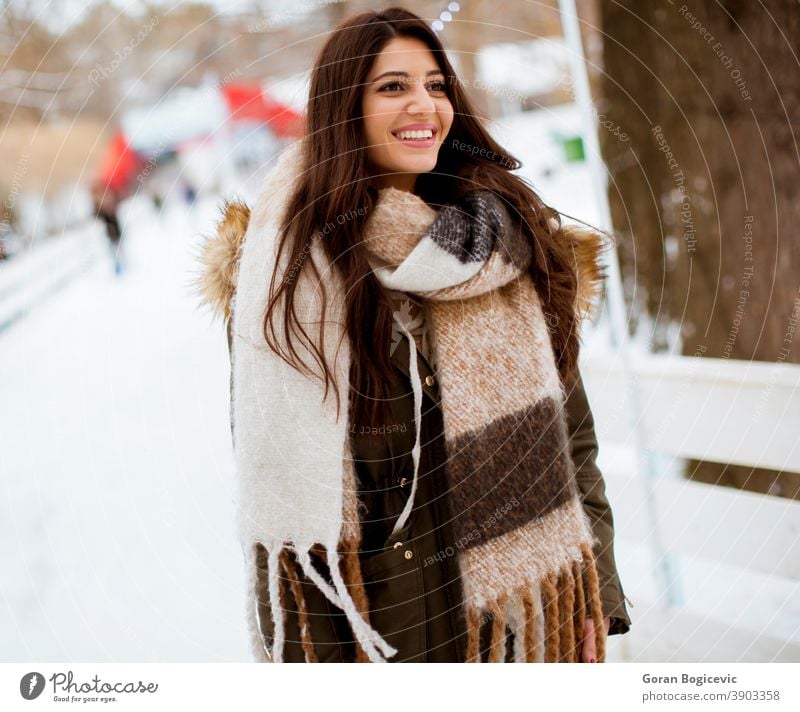 Young woman in winter park adult attractive beautiful beauty casual caucasian christmas cold cool face fashion female frost fun girl happiness happy hat holiday