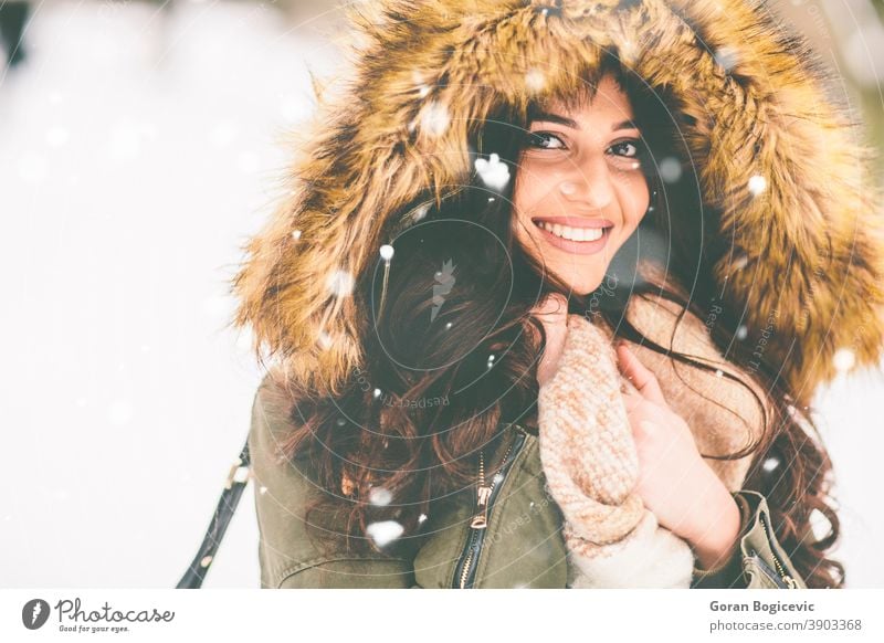 Young woman with fur hood in the park on the snow pretty Close-up garments Coat Cold Fashion Woman Pelt Girl Happy Hooded (clothing) Jacket Nature Outdoors Park