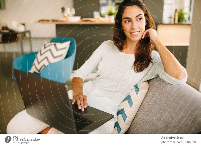 Young woman working on laptop at home using freelance remote casual young online female device gadget browsing internet lifestyle surfing distance connection