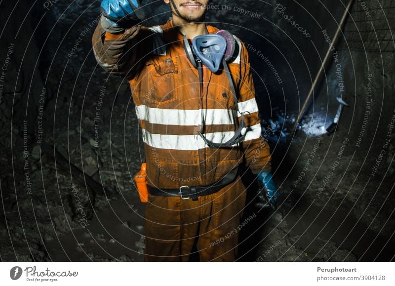 Miner smiling inside the mine miner worker coal man safety underground professional helmet business engineering hard industrial labor male person power shaft