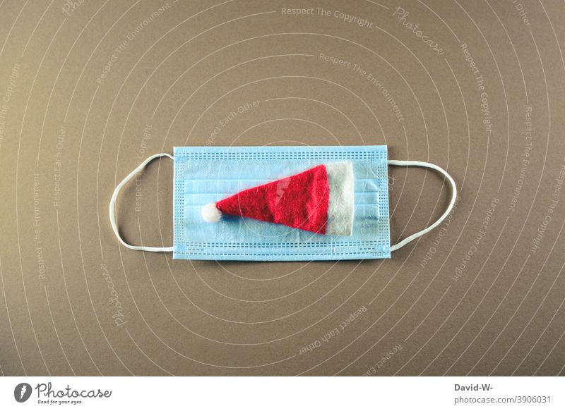 Santa hat and mouth guard - symbol - corona for christmas time Christmas & Advent coronavirus pandemic Respirator mask Mask Quarantine Risk of infection