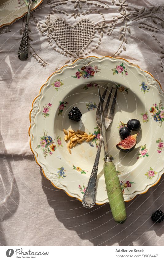 Empty plate with leftovers of fruits on table empty food messy dirty melon grape ripe organic rustic kitchen nutrition tasty natural meal sweet fresh product