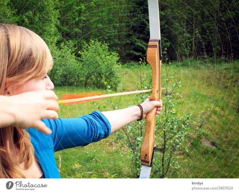 young woman shoots bow in nature. Archery. Recreational sport archery recreational sport arrow and bow Aim Shoot Nature Shot Leisure and hobbies Arrow Weapon