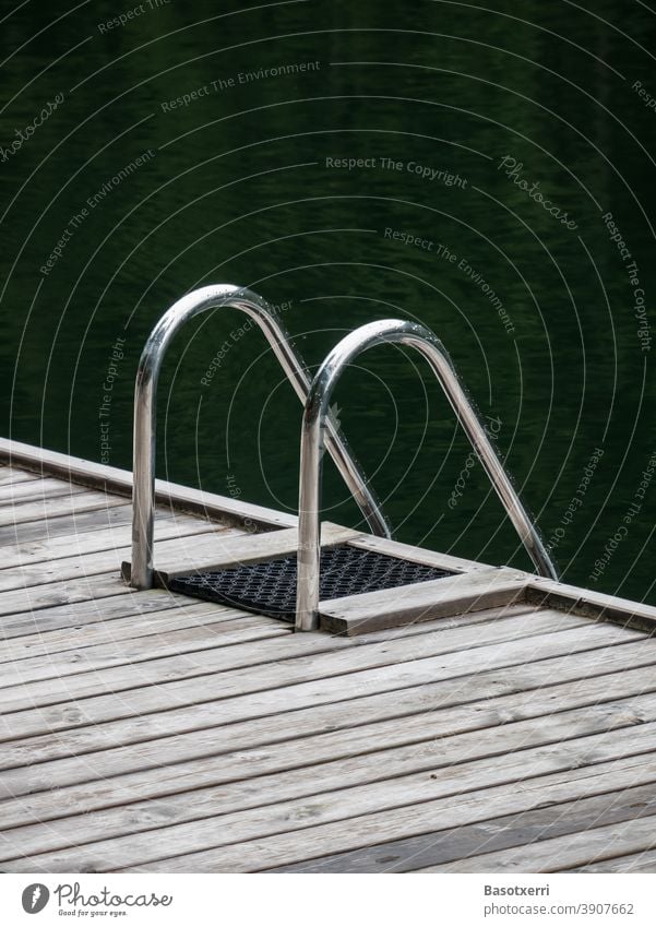 Detail picture of a bathing platform in the lake Lake Pond Ladder pool Wood Door handle Bracket entry exit Help prop be afloat Swimming pool bathe Swimming lake