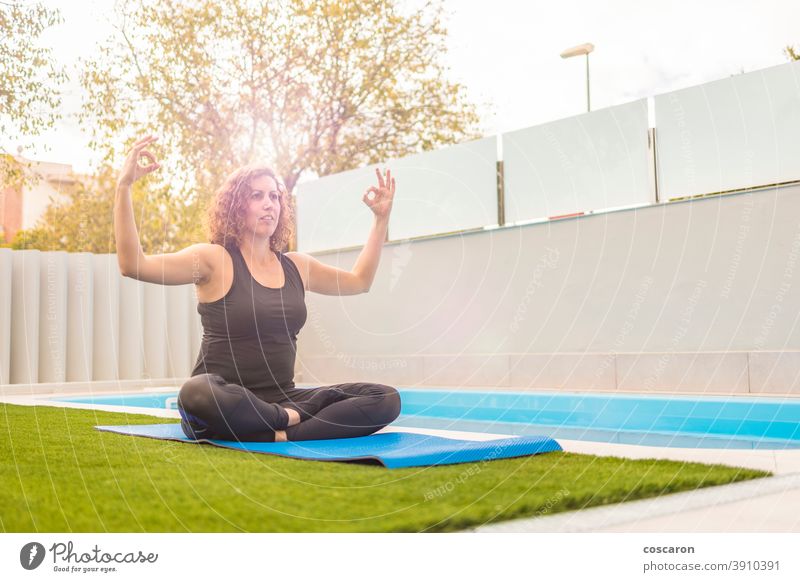 Middle aged woman doing yoga execises in her home garden activity background beautiful body caucasian concentration concept copy space enjoyment exercise female