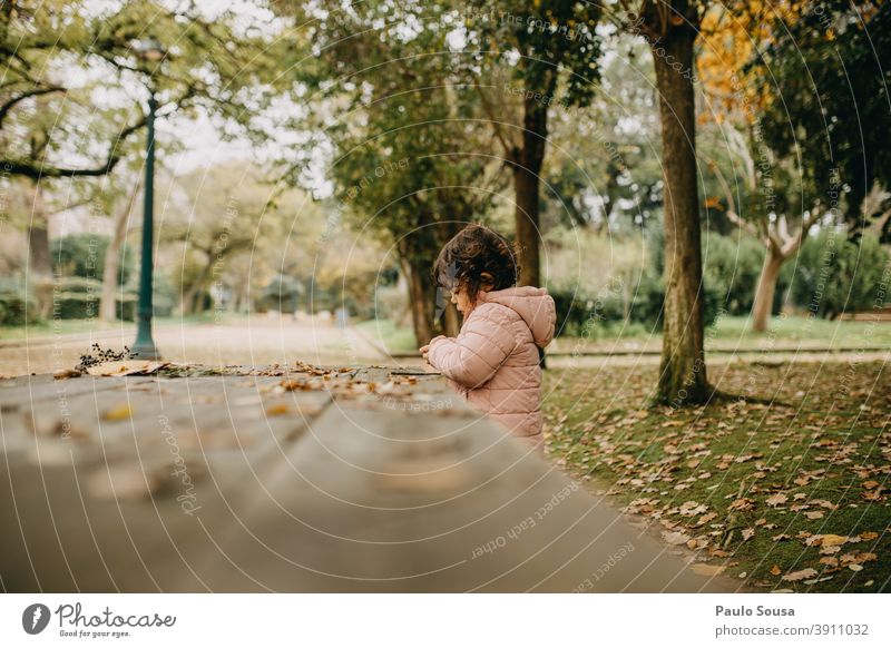 Cute child girl playing at the park Autumn Authentic Autumnal Autumn leaves Autumnal colours fall Early fall Nature Colour photo Autumnal weather Exterior shot