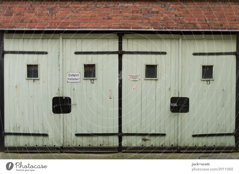 Multi-purpose garages no. 12 and 13 Garage GDR Garage door Ravages of time Prenzlauer Berg Retro Smiley Closed Old Sharp-edged Symmetry Past Style Weathered