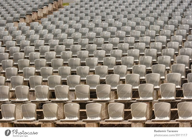 rows of plastic seats in the stadium event chair empty concert seating nobody background sport pattern stand bench audience section horizontal theater color