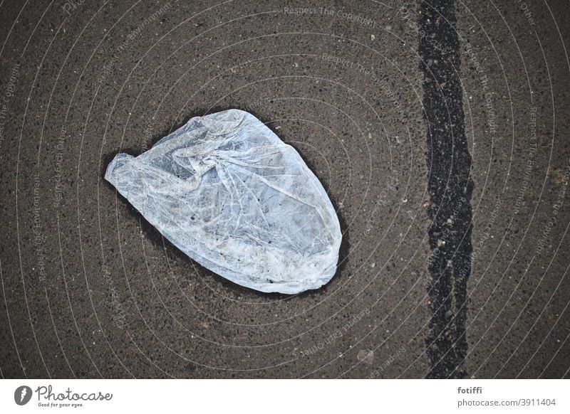 Plastic bag sticks to the floor Zettberlin Paper bag Concrete plastic Exterior shot Deserted Environment Trash Pattern Wet Packaging Stick Packing film