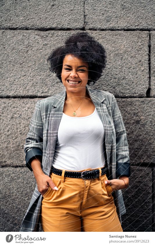 Afro Girl in Street Portrait looking at camera woman young portrait street afro girl african american black woman smiling expression front view one person