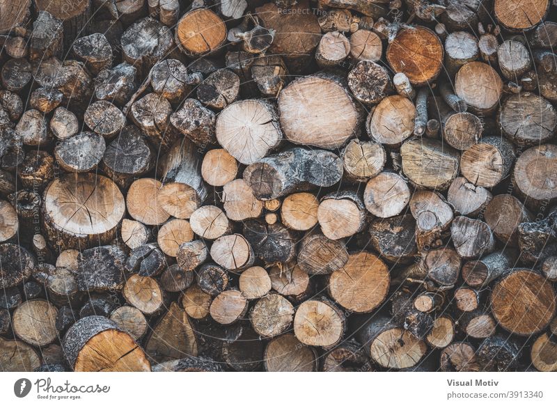 Detail of stacked wooden logs prepared to be used as firewood countryside rustic woodpile resource texture background natural various timber rural structure