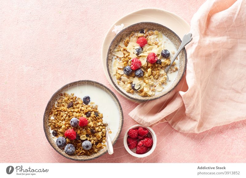 Breakfast with granola, berries and milk breakfast food healthy organic cereal fruit muesli berry bowl grain diet flake snack yogurt fresh natural sweet dessert