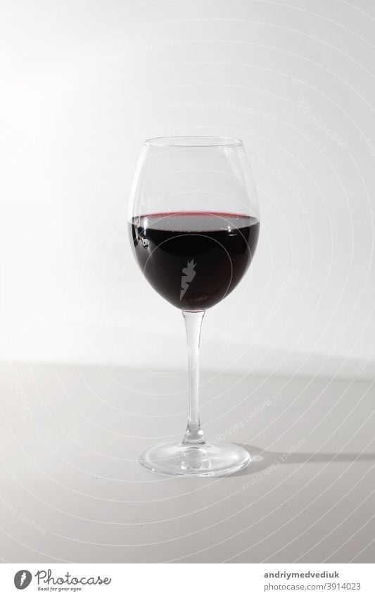 Glass of red wine isolated on white background. A glass of red wine. Copy space. drink alcohol celebration wineglass merlot cabernet splash abstract closeup